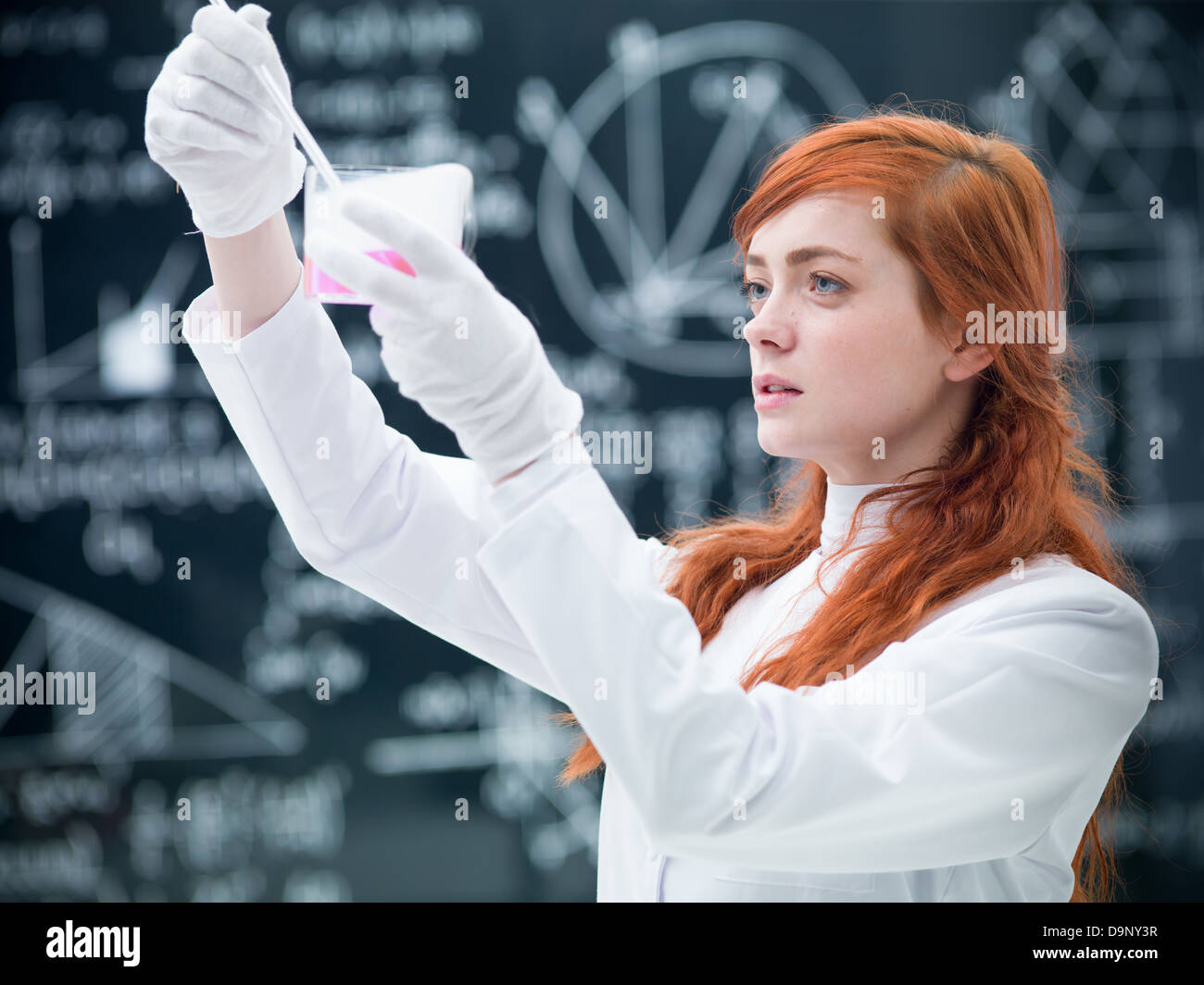 closeup of student in a chemistry lab analysing and observing colorful