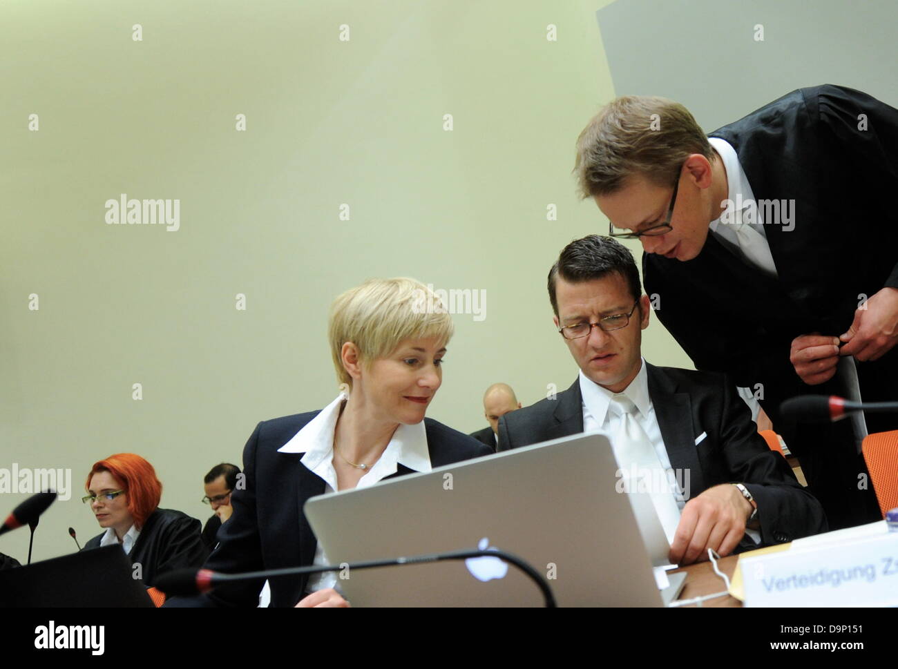 The lawyers of the defendant Zschaepe, (FRONT L-R) Anja Sturm,  Wolfgang Stahl and Wolfgang Heer, talk inside the court room in Munich, Germany, 24 June 2013. The trial of the murders and terror attacks of German terror cell 'National Socialist Underground' (NSU) continues at the Higher Regional Court in Munich. The court has called witnesses. Photo: Tobias Hase Stock Photo