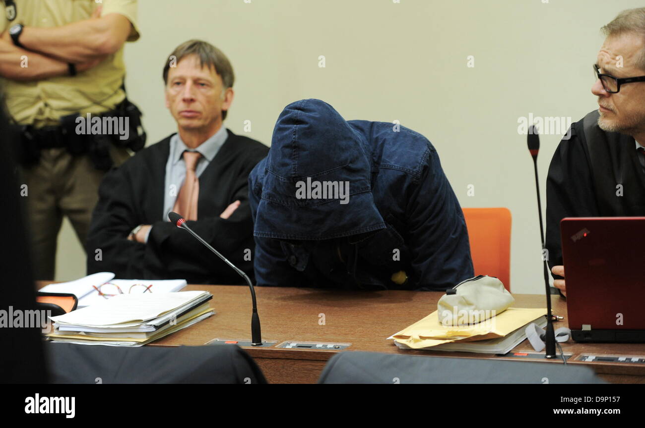 The defendant Carsten S. (C) sits between his lawyers Johannes Pausch (L) and Jacob Hoesl inside the court room in Munich, Germany, 24 June 2013. Henning Sass examined defendant Beate Zschaepe. The trial of the murders and terror attacks of German terror cell 'National Socialist Underground' (NSU) continues at the Higher Regional Court in Munich. The court has called witnesses. Photo: Tobias Hase Stock Photo