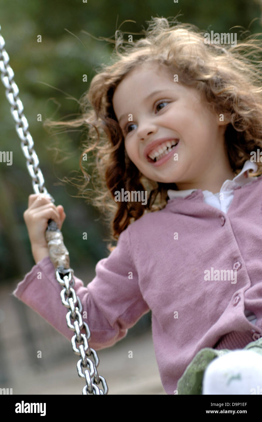 Girl on a swing with long hair hi-res stock photography and images - Alamy