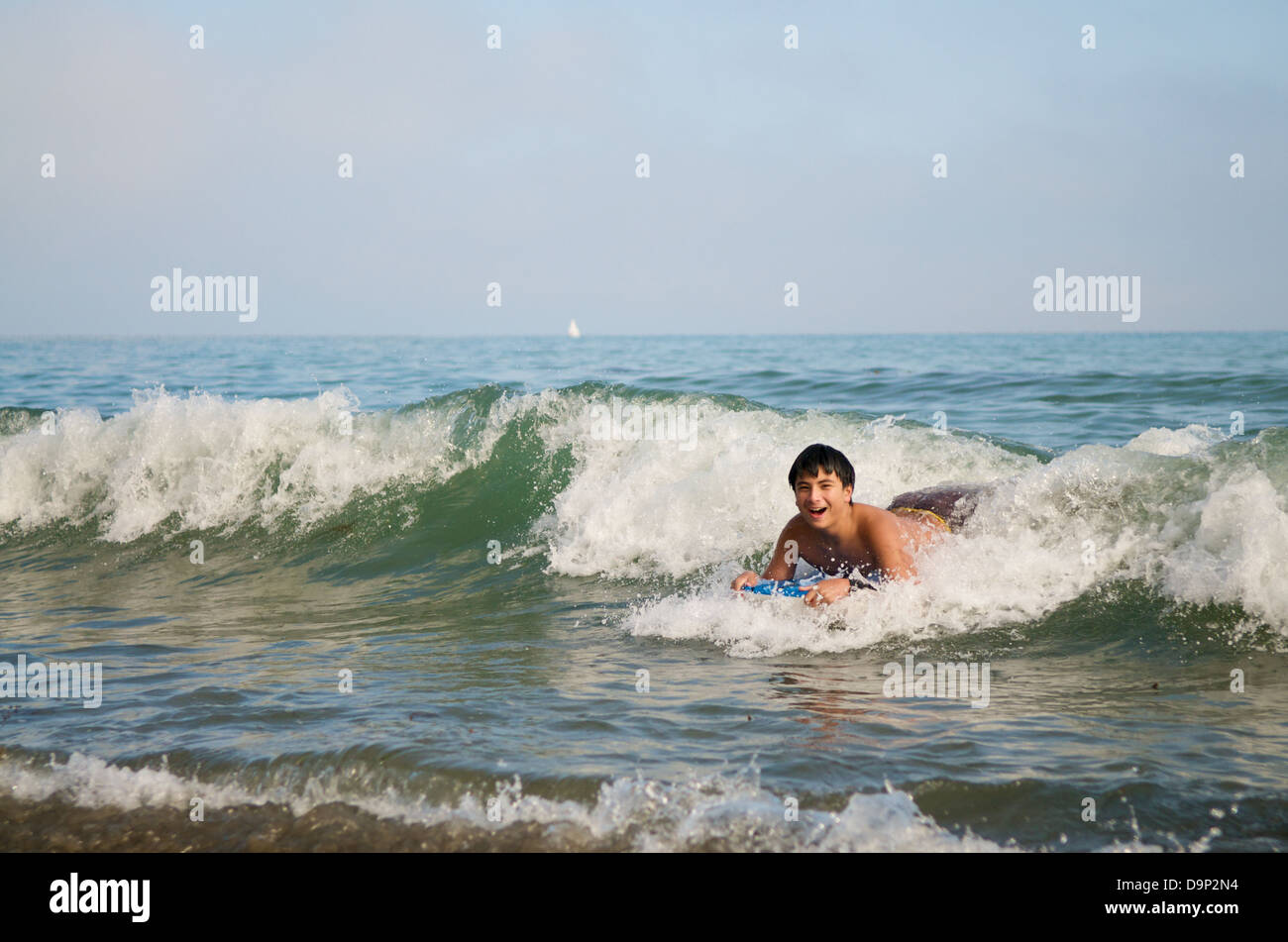Boy surfing on the beach with boogie boards Stock Photo Alamy