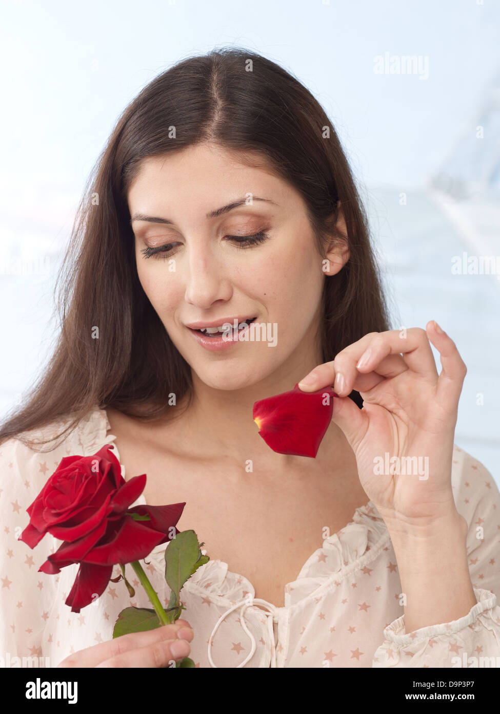 Woman plucking rose petals Stock Photo Alamy