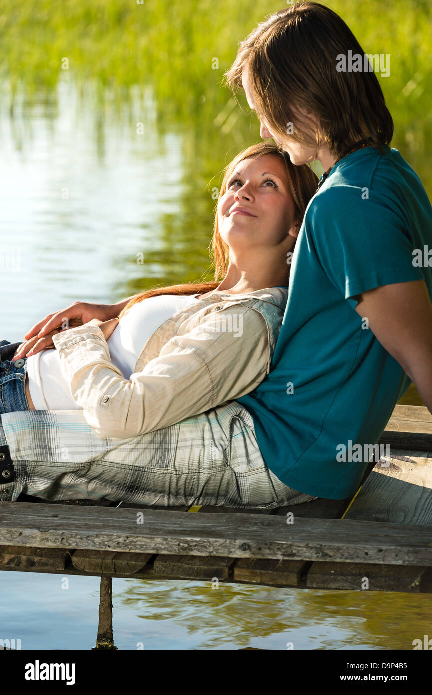 Peaceful romantic couple lounging on the pier Stock Photo