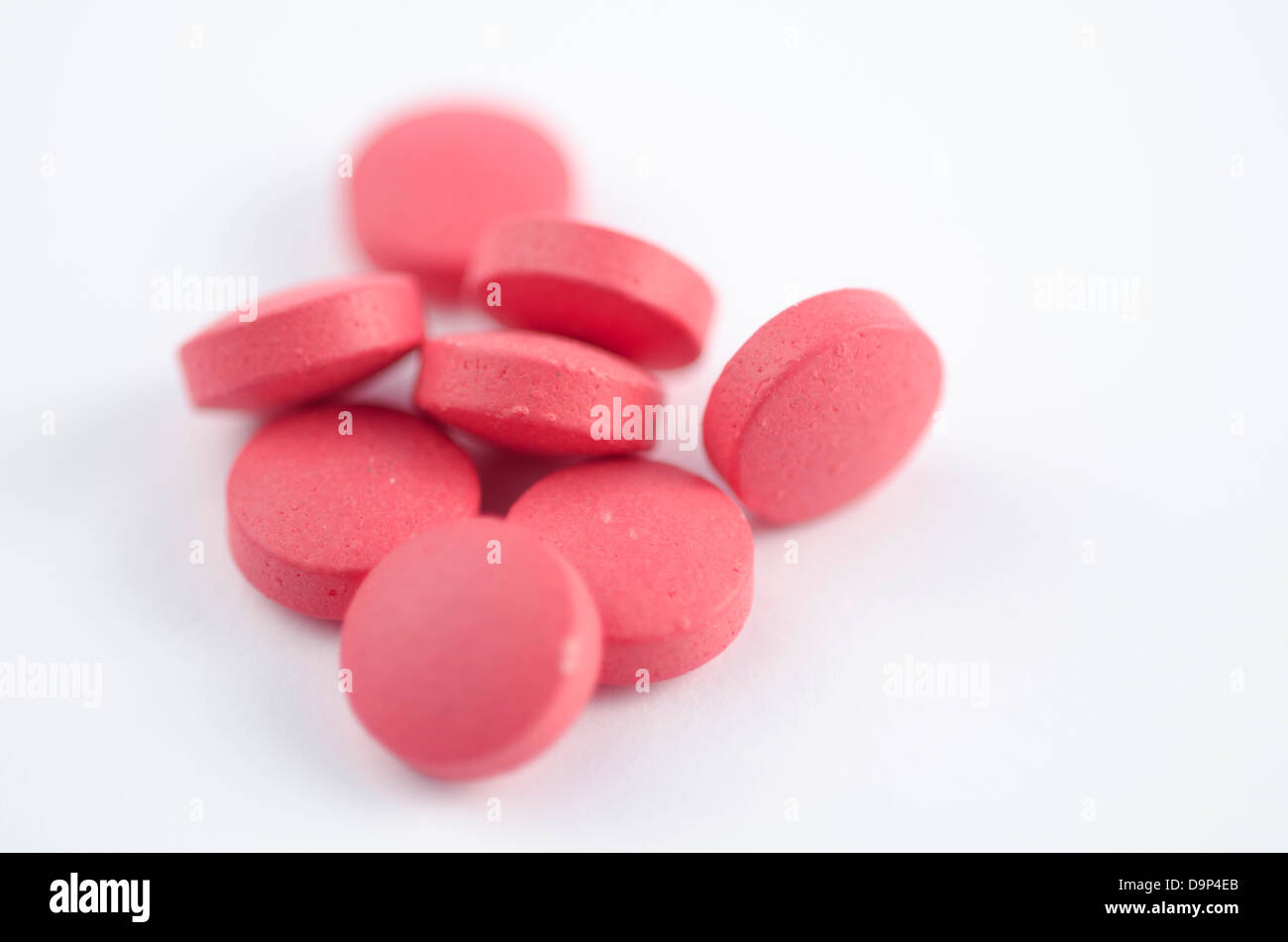 Medical health remedies, a pile of pink pills medication Stock Photo