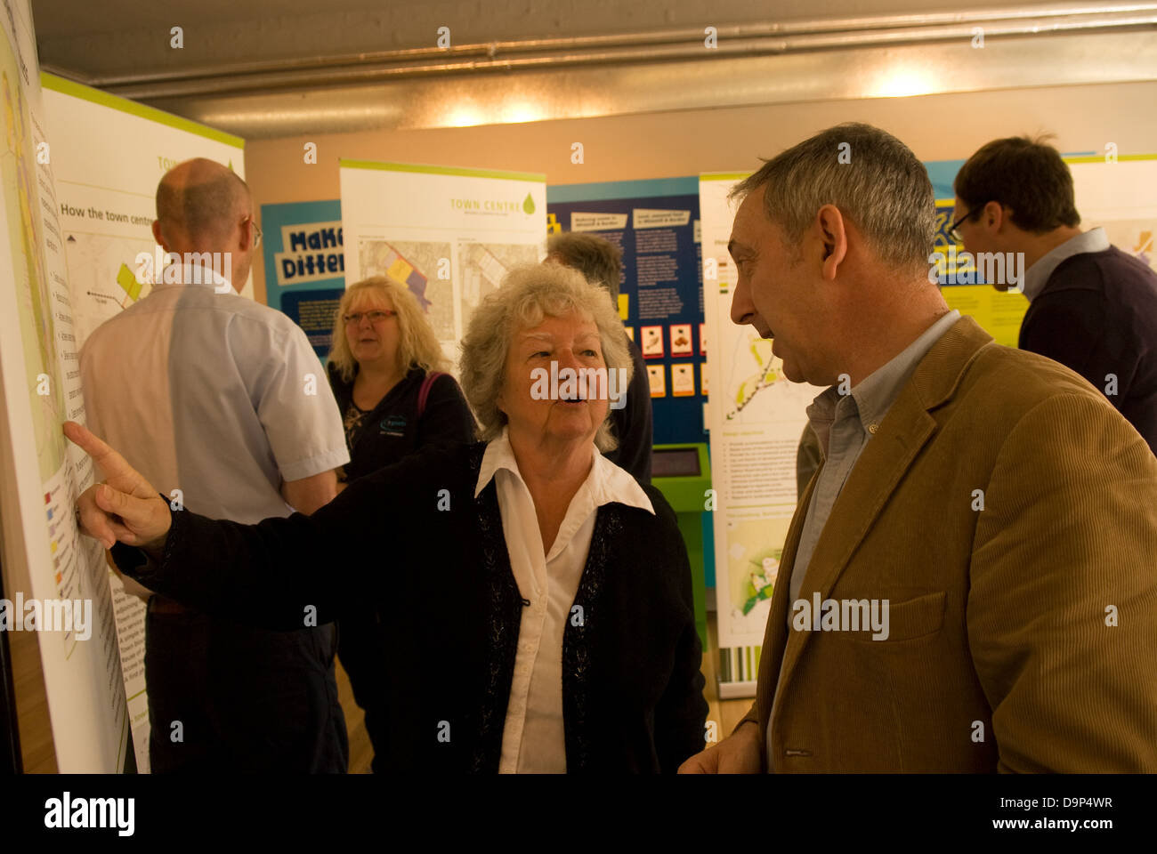 Local residents & town planners discussing & perusing plans for new eco town at Eco Station, Bordon, Hampshire, UK. Stock Photo