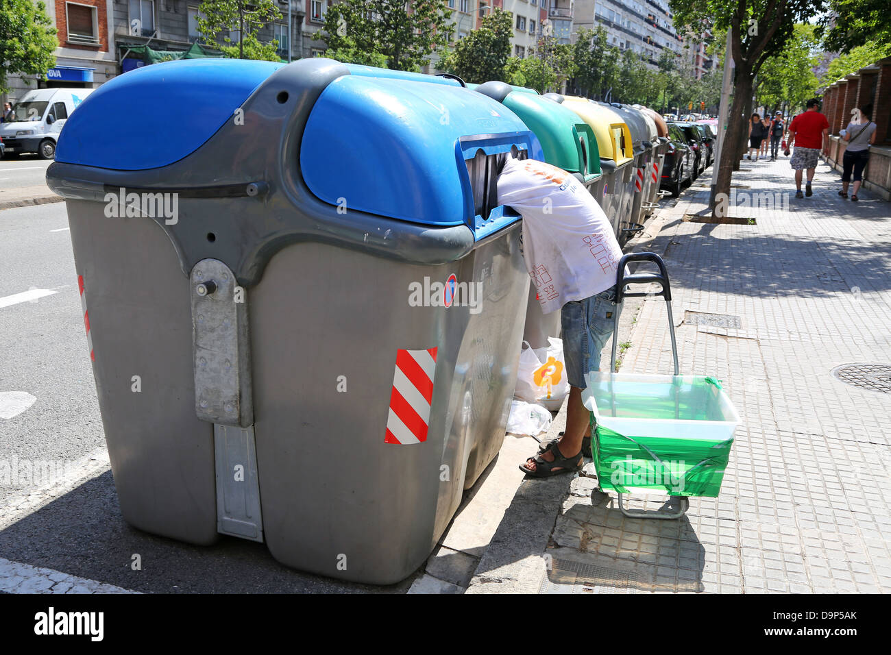 Man scavenging in recyling bins in Barcelona, Spain Stock Photo Alamy