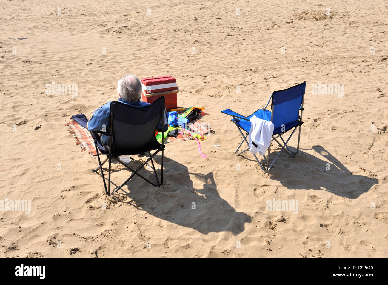 Older man sitting on chair, Summer British Seaside Stock Photo