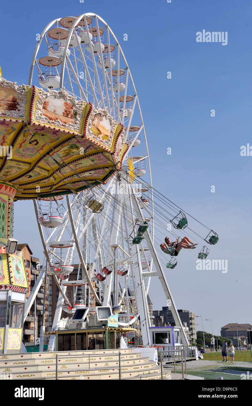 Carousel with aerial chairs and Ferris wheel Weston Super Mare, UK Stock Photo