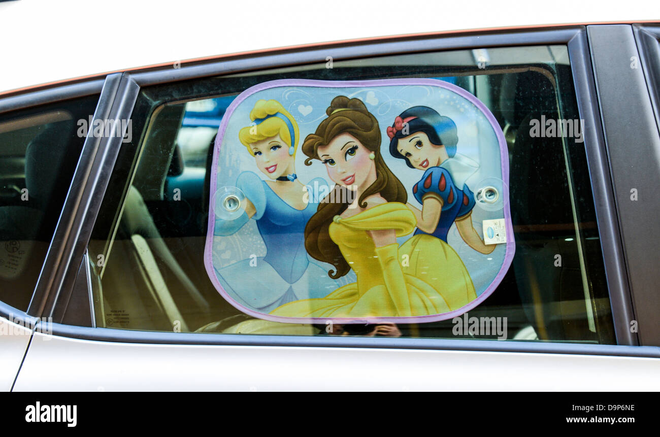 A sun-screen on a car with an image of three ladies Stock Photo