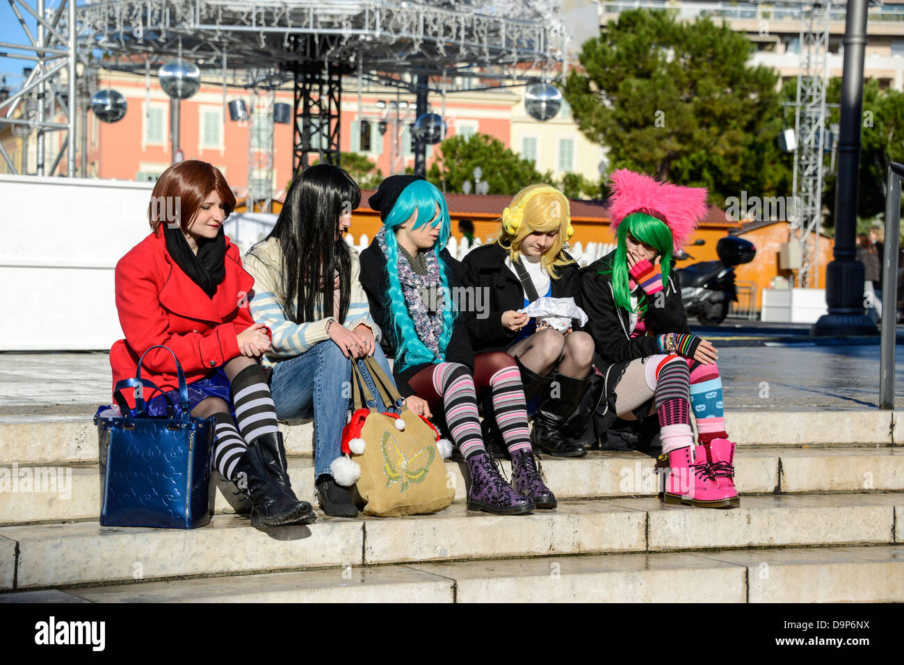 Young girls dressed up as punk rockers with multi colored wigs in Nice France Stock Photo