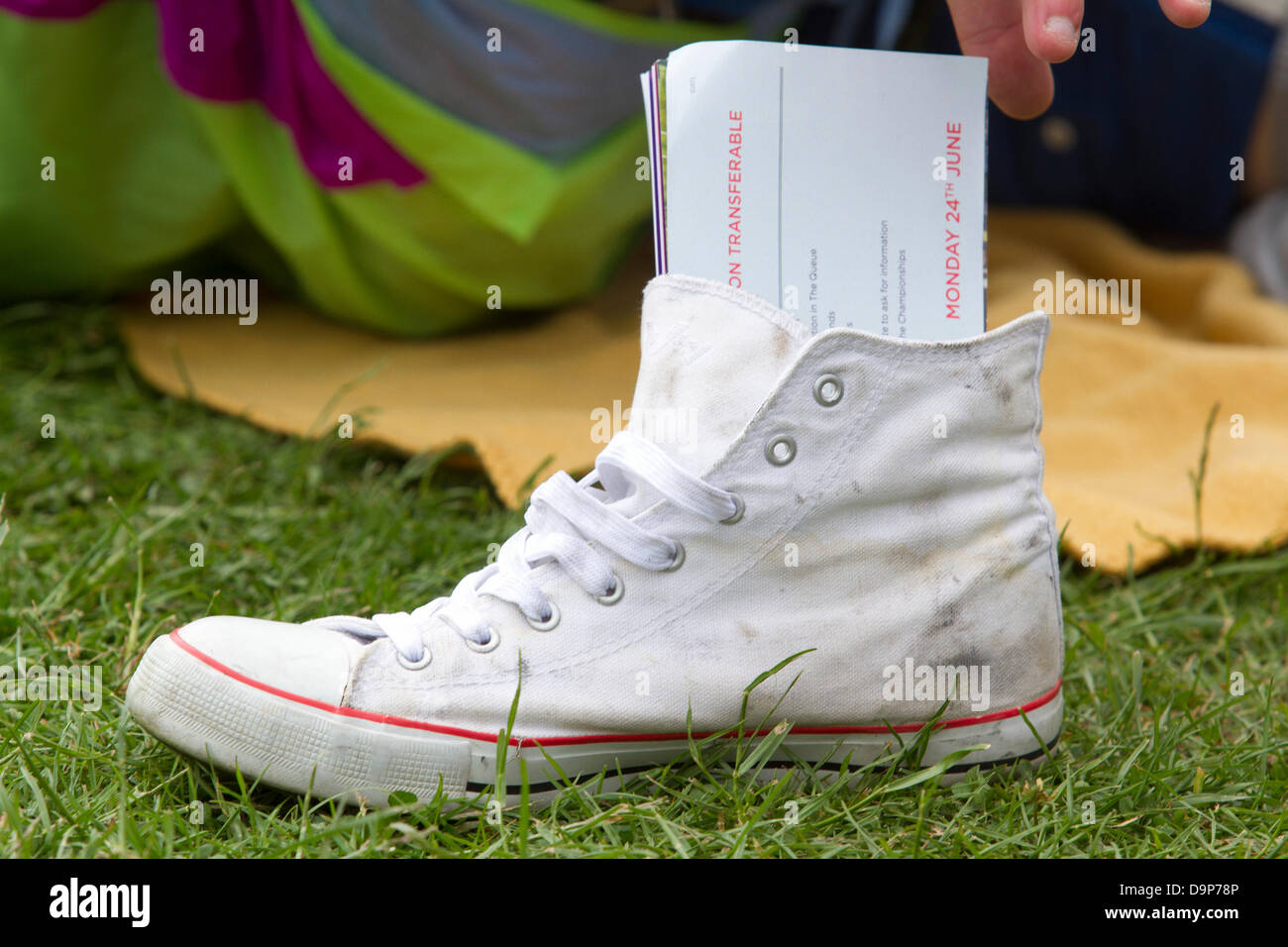 Wimbledon, London, UK. 24th June 2013. A queue card in a shoe as large crowds queue on a cold