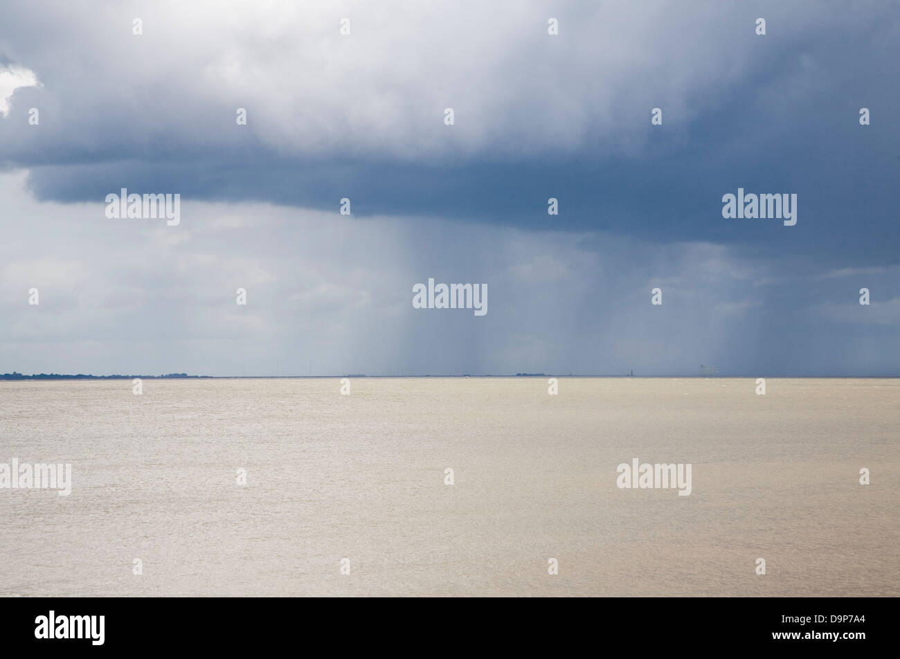 Heavy rain showers falling on sea from nimbocumulus cloud Orford Ness