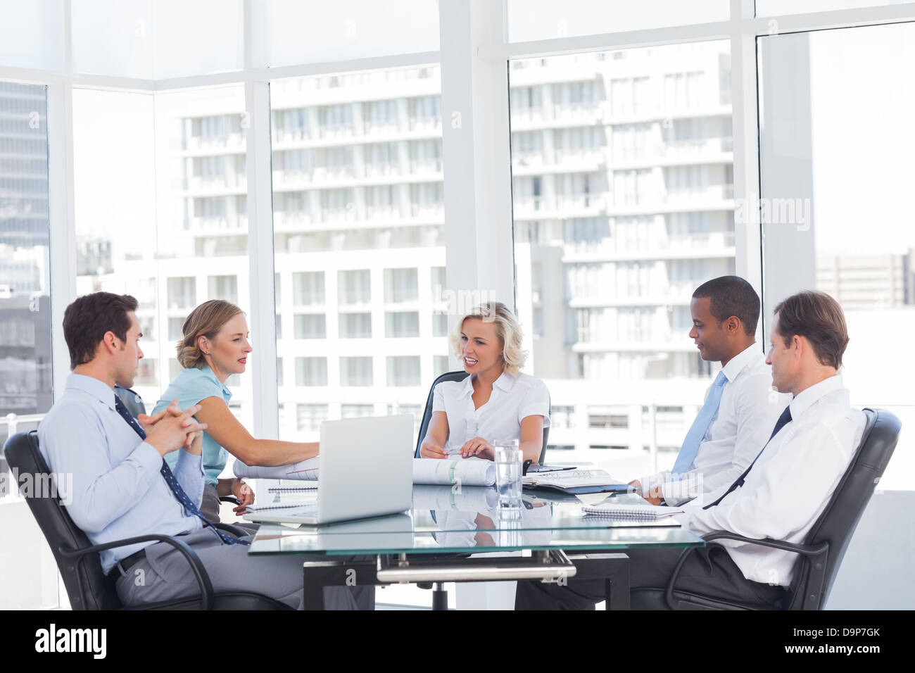 Smiling business people discussing together Stock Photo - Alamy