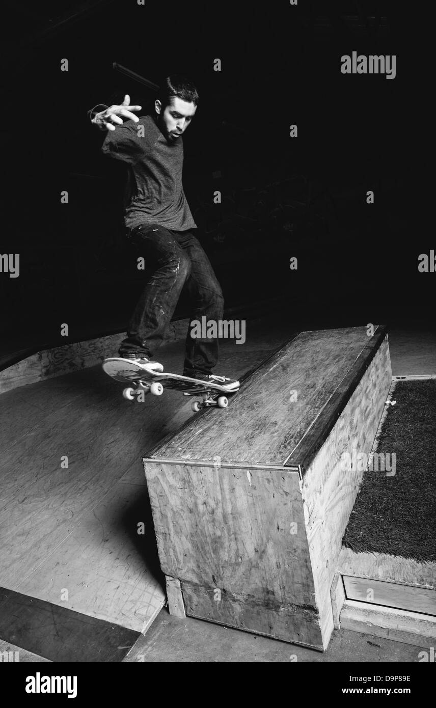 Skater doing impressive backside grind Stock Photo