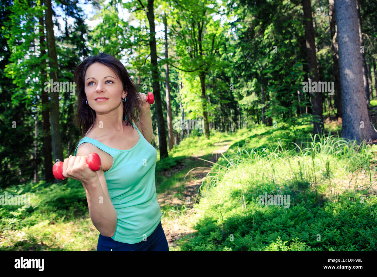 young woman jogging in a forest Stock Photo - Alamy