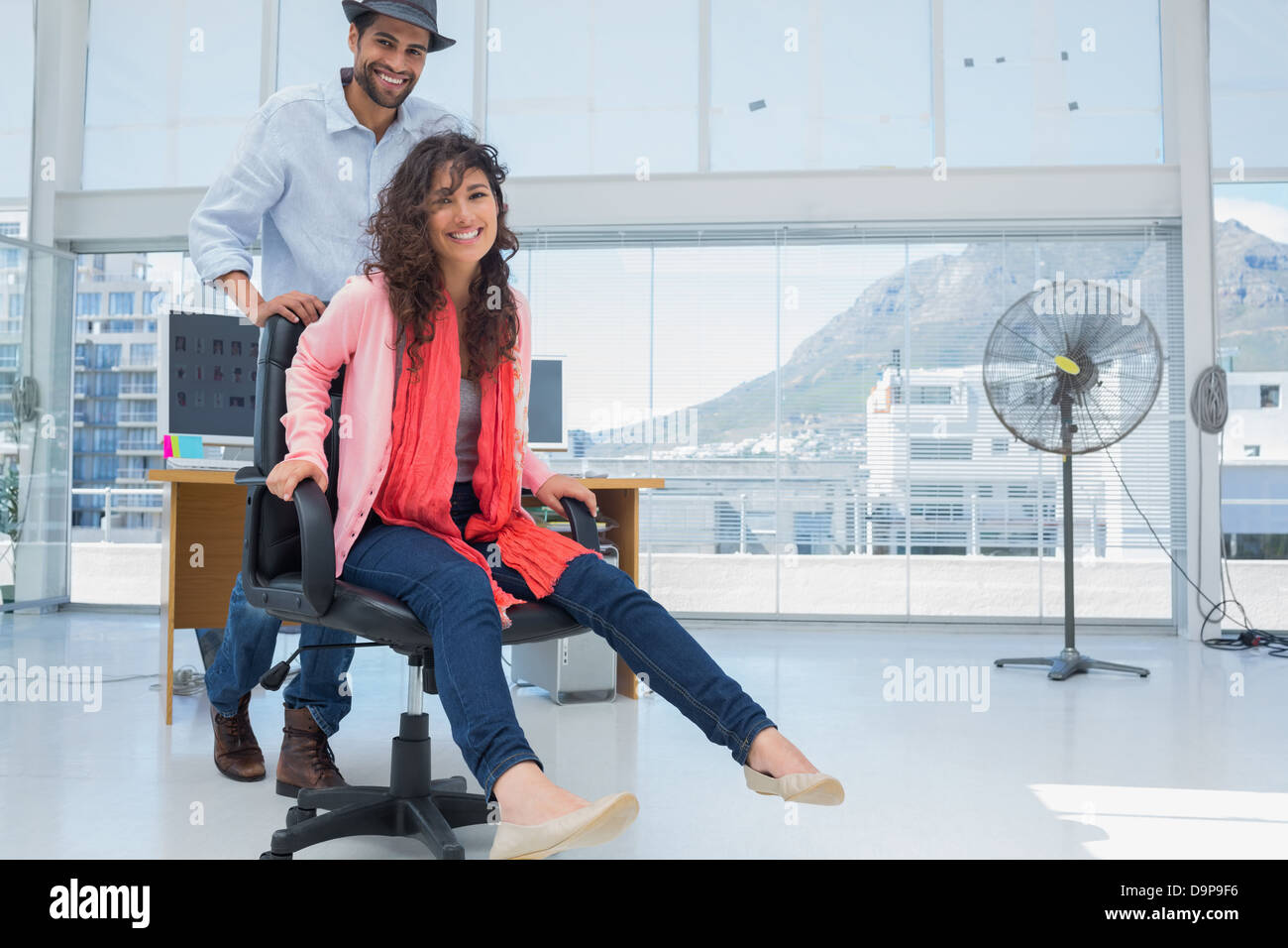 Creative business team having fun on the office chair Stock Photo