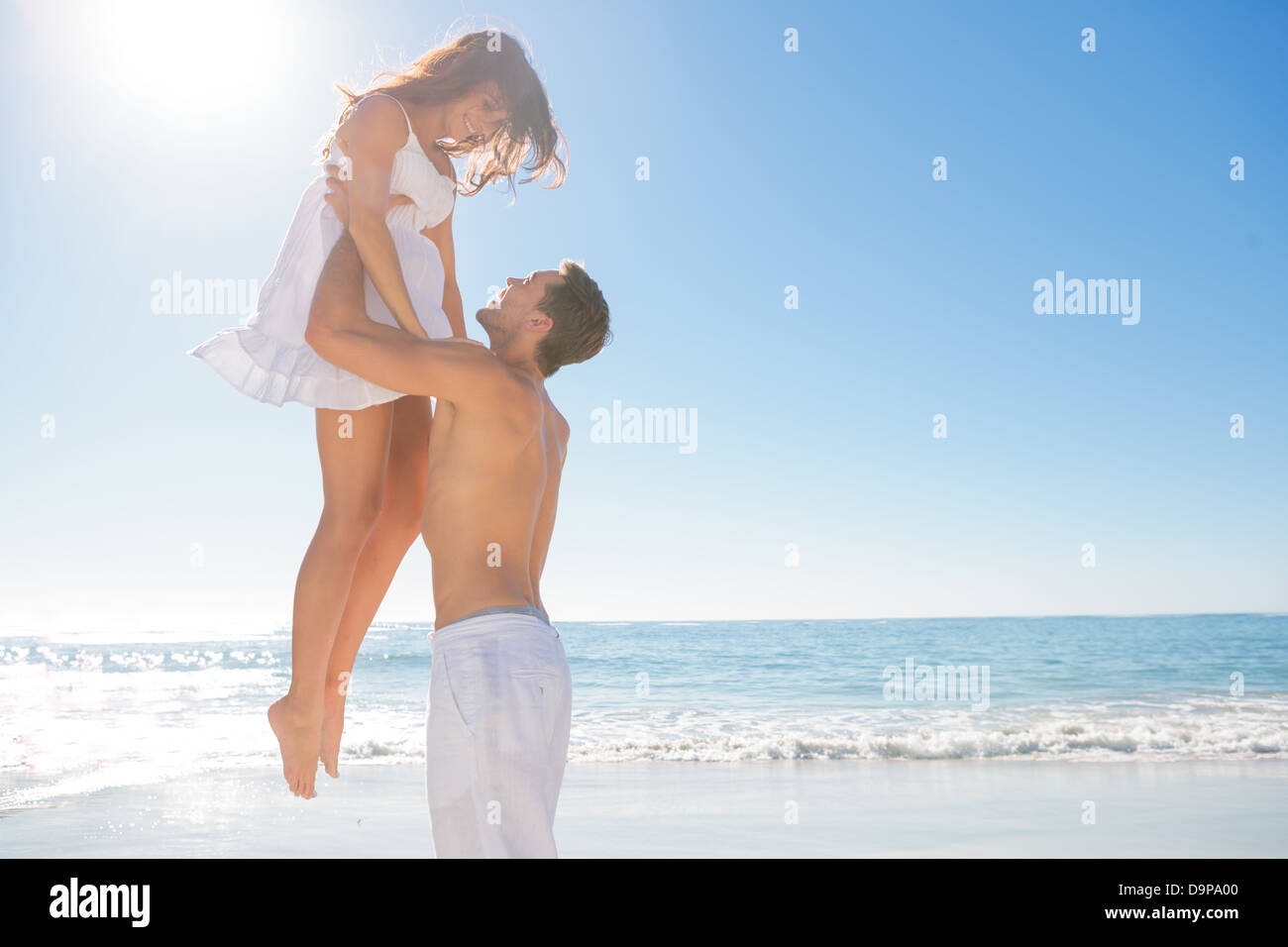 Handsome man holding his wife Stock Photo