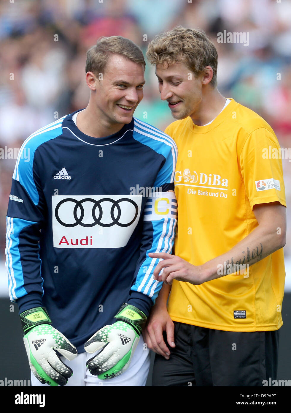 German national goalkeeper Manuel Neuer (L) and soccer player Stefan Kiessling talk during the charity soccer match between 'Manuel Neuer & Friends' and 'Nowitzki Allstars' in Wuerzburg, Germany, 23 June 2013. The proceeds from the event went to the project 'Soccer meets Culture' of the international LitCam campaign. Photo: DANIEL KARMANN Stock Photo