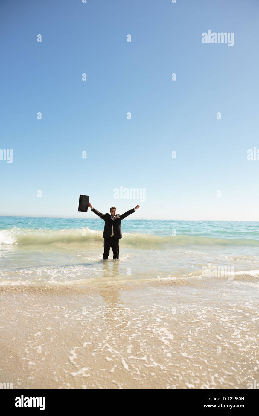 Businessman raising his arms Stock Photo - Alamy