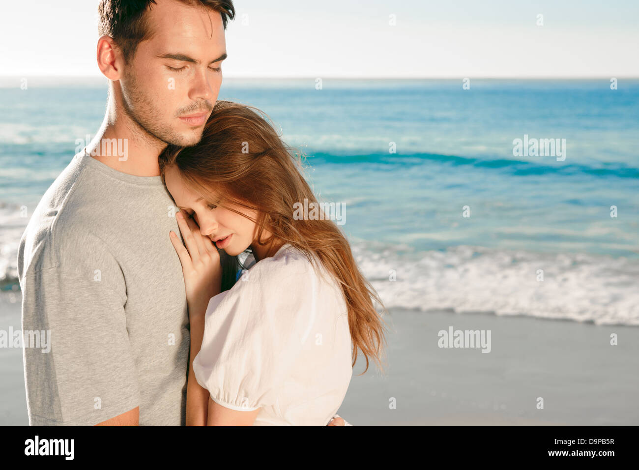 Couple relaxing on the beach Stock Photo - Alamy
