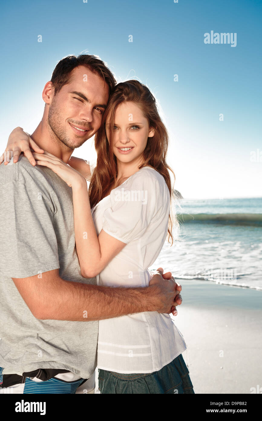 Young couple embracing and posing on the beach Stock Photo