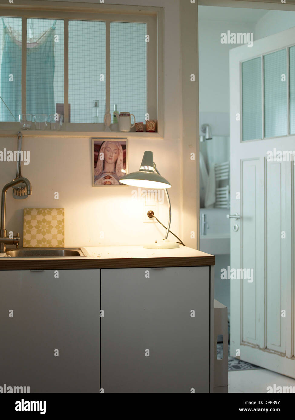 Kitchen with table lamp and religious icon on the wall Stock Photo