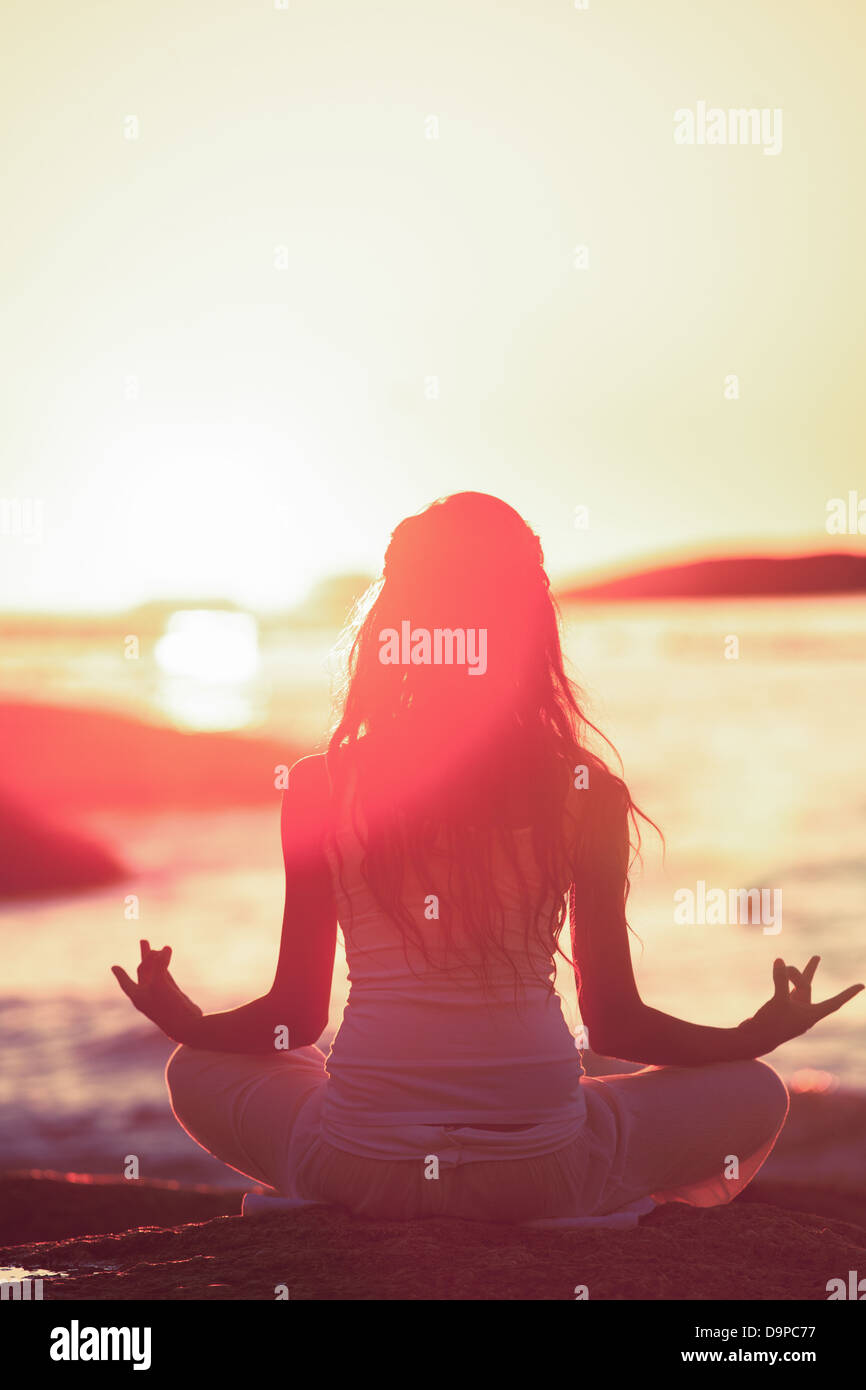 Silhouette of woman meditating Stock Photo - Alamy