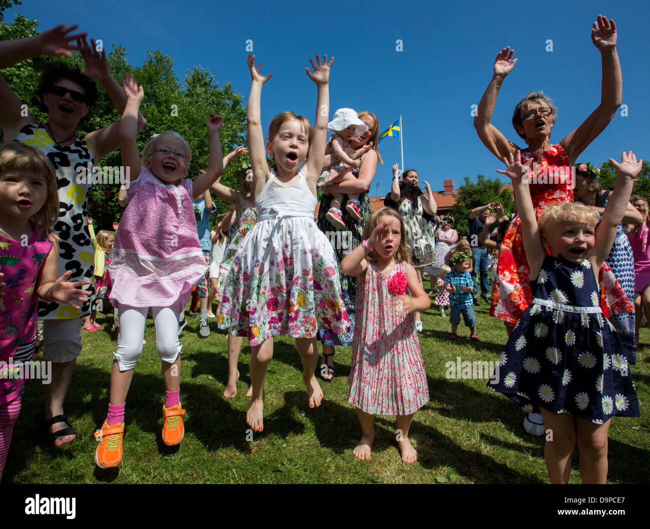 Midsummer celebration with dancing around the maypole Stock Photo
