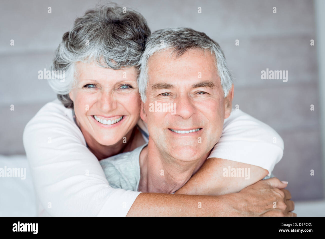 Mature woman embracing her husband Stock Photo