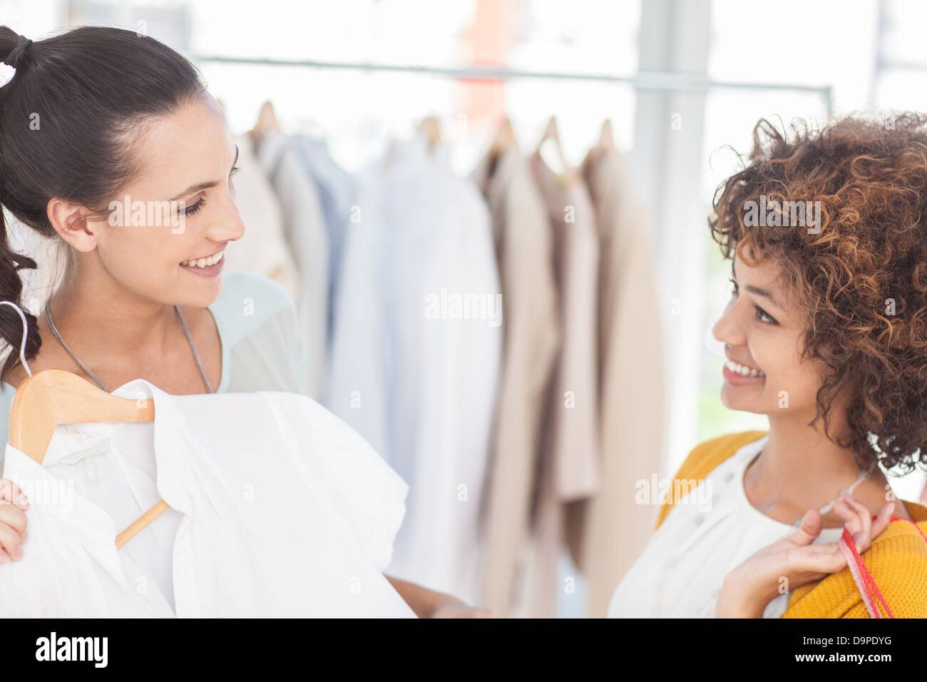Attractive woman showing her new dress to a friend Stock Photo