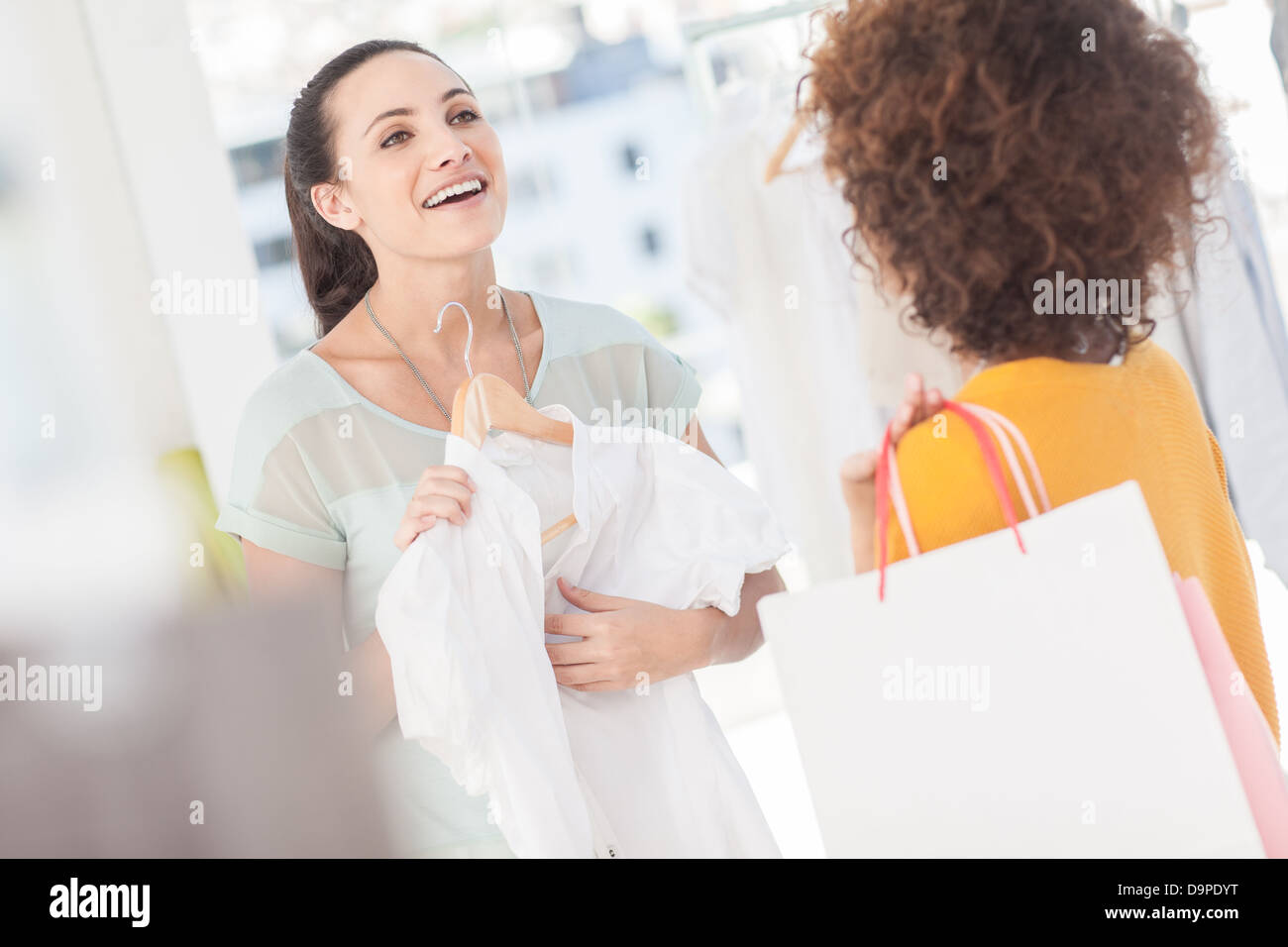 Woman showing her new dress to her friend Stock Photo