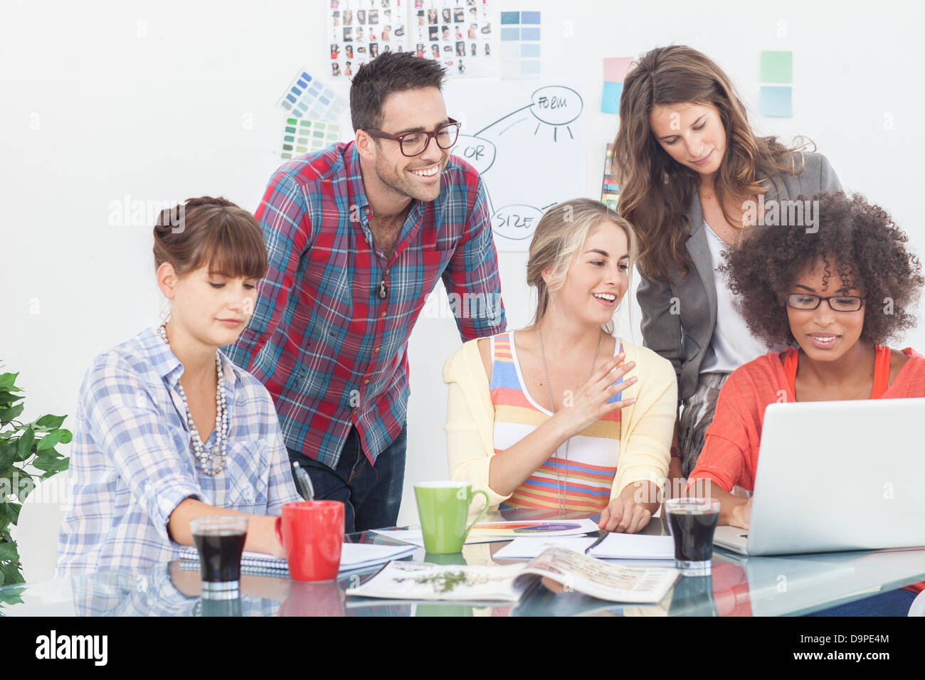 Team of creative designers working on a laptop Stock Photo - Alamy