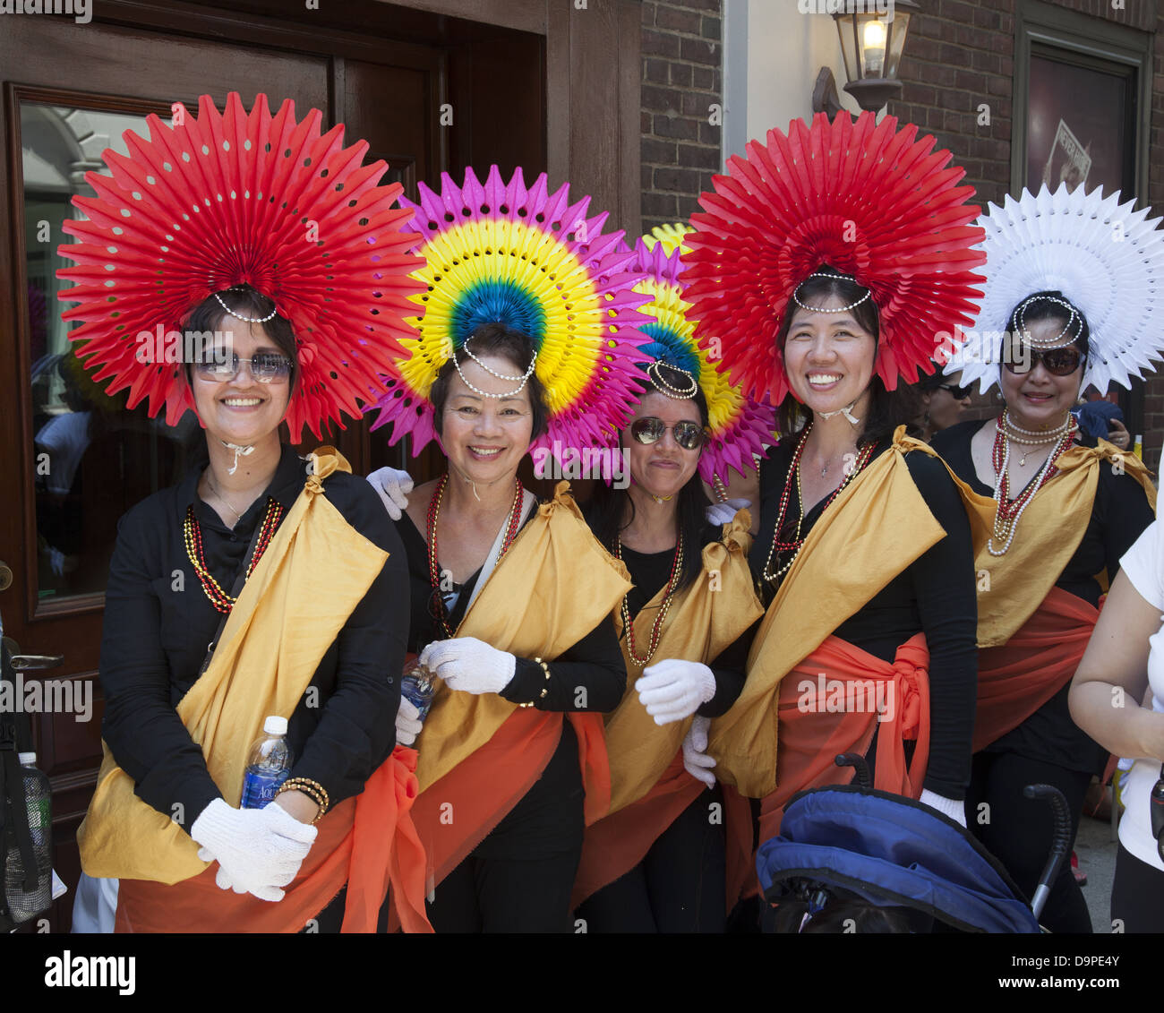 Women in colorful costumes ready to perform in the Filipino Parade on Madison Ave. in NYC Stock Photo