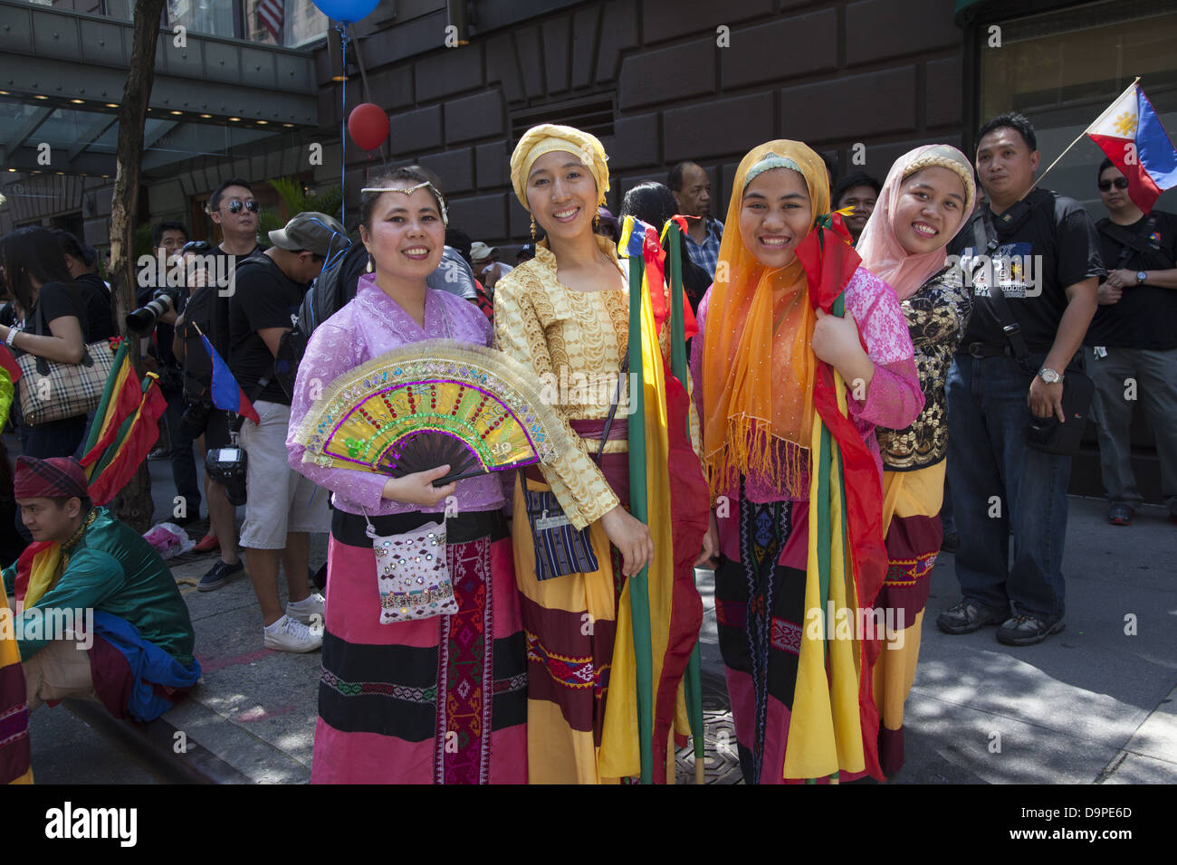 Women in colorful costumes ready to perform in the Filipino Parade on Madison Ave. in NYC Stock Photo