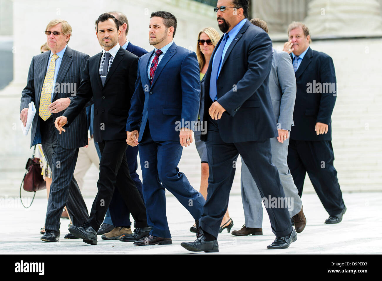 Washington, District of Columbia, USA. 24th June, 2013. Propositon 8 plaintiffs Paul Katami (second from left) and Jeffrey Zarrillo hold hands as they leave the U.S. Supreme Court in Washington, D.C. on Monday. The Court did not rule on the much awaited DOMA and Prop. 8 cases but did affirm the use of race in the admissions process at colleges and universities but made it harder for institutions to use such policies to achieve diversity. Credit: Pete Marovich/ZUMAPRESS.com/Alamy Live News Stock Photo