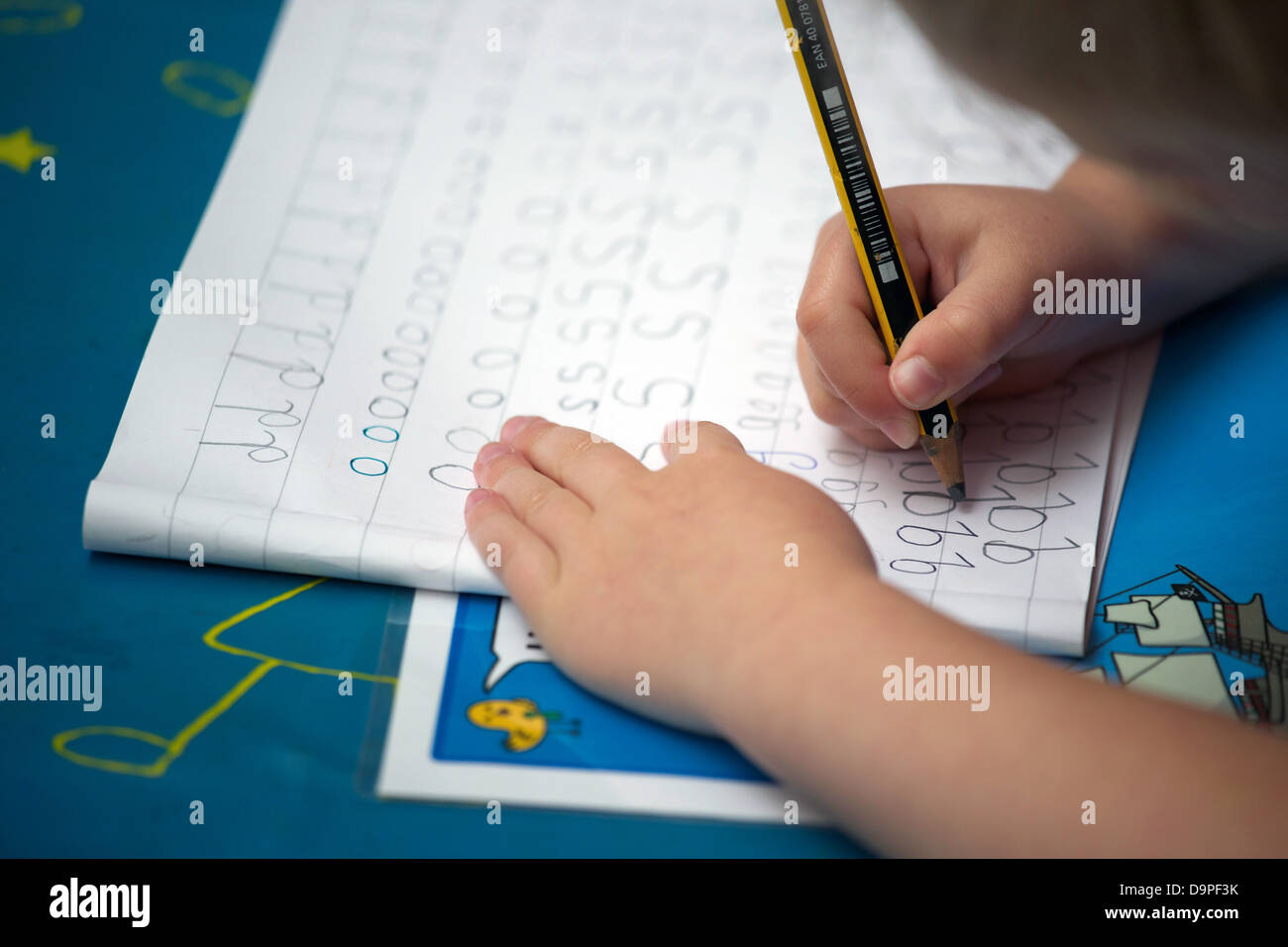 Close up of a UK primary school child doing handwriting practice. Stock Photo