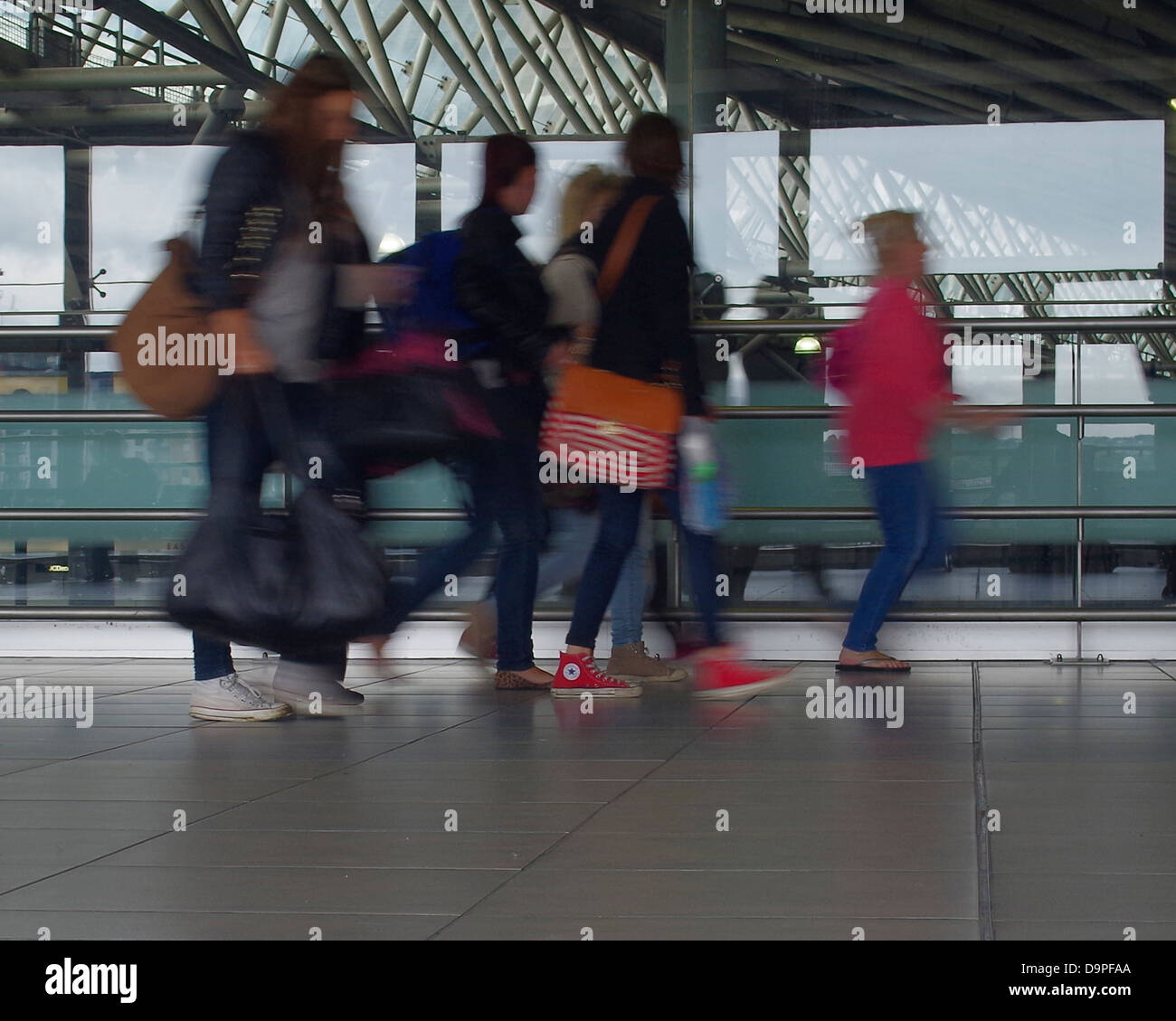 A group of women late rush to catch public transport to work, Motion blur to show movement. Leeds railway station Stock Photo