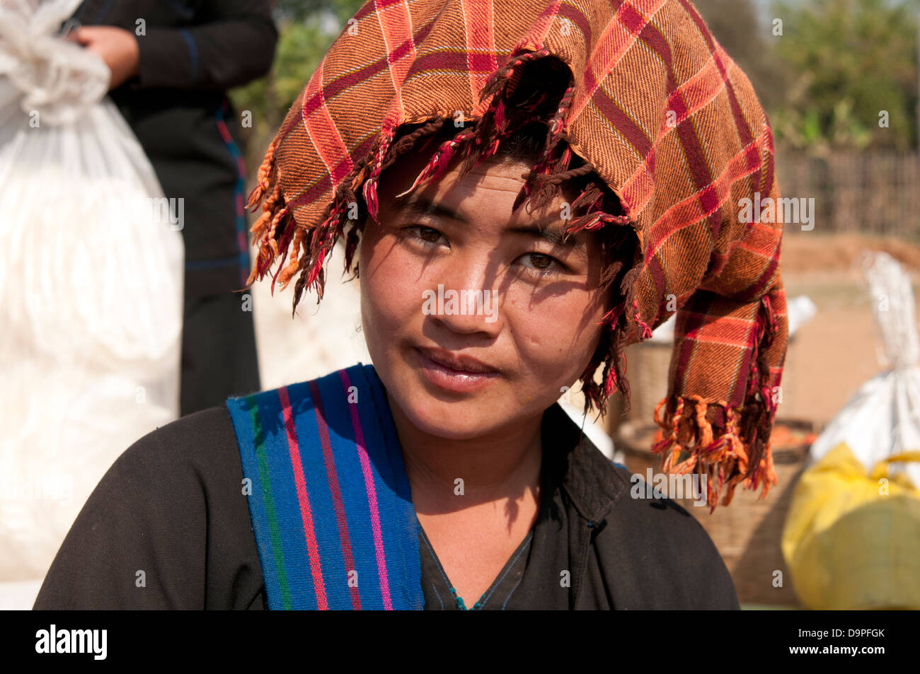 Young Pa-O woman wearing orange checked traditional headdress smiling ...