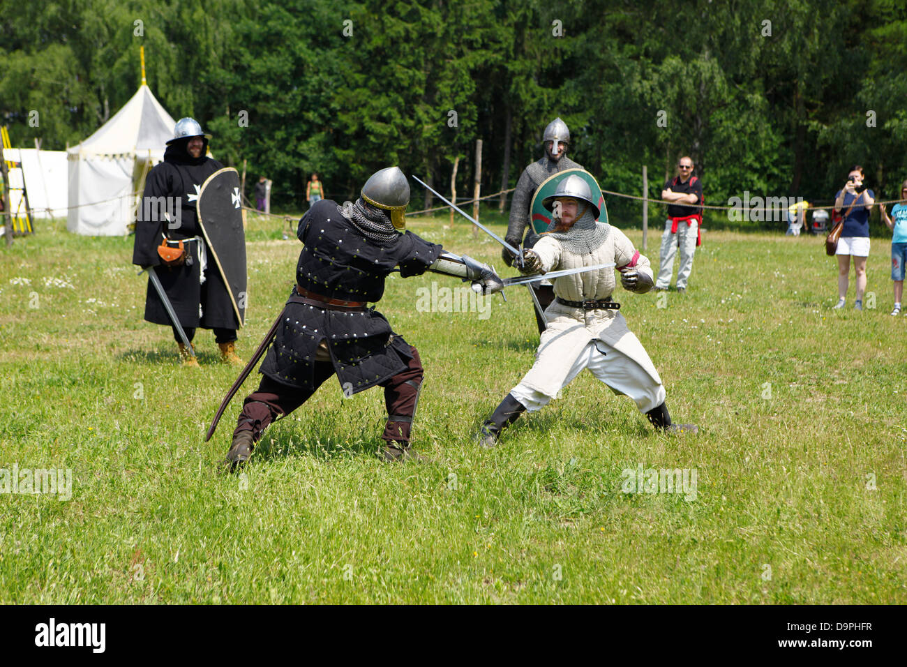 Two medieval european knights armed and fashioned fighting on a battle field Stock Photo