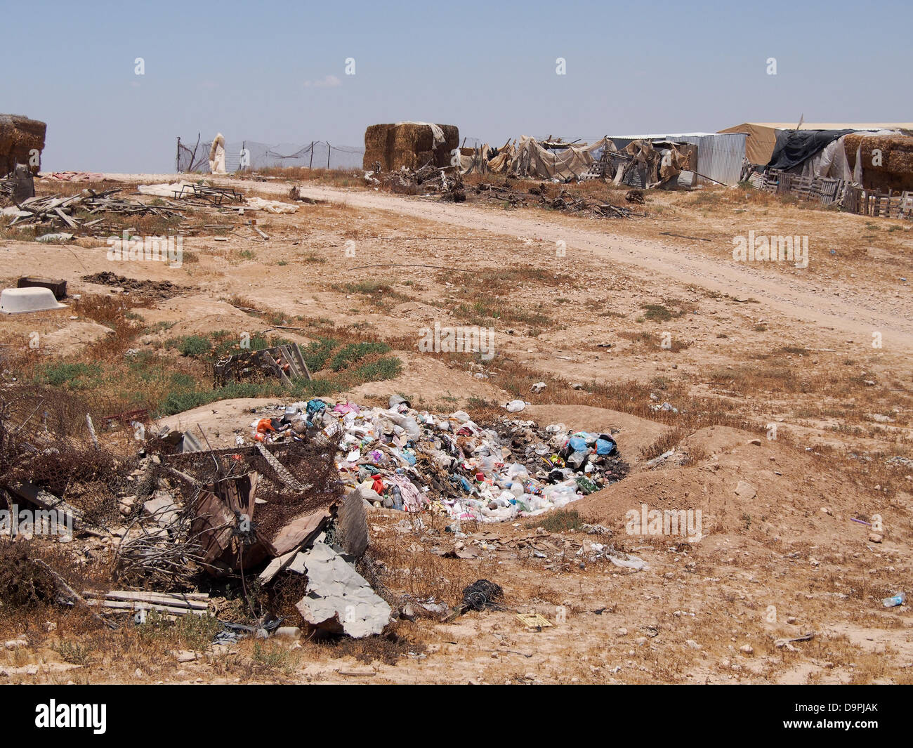 Israel. 24th June, 2013. With no municipal services or garbage evacuation, garbage accumulates and is sometimes burned in open pits in the unrecognized Bedouin village of Al Sir. Odor and fumes create pollution and lung disease.   The Prawer-Begin proposition seeks to regulate the settlement of Bedouins in the Negev and is expected to pass in the Knesset tonight in the first of three readings in spite of Bedouin opposition. Credit:  Nir Alon/Alamy Live News Stock Photo