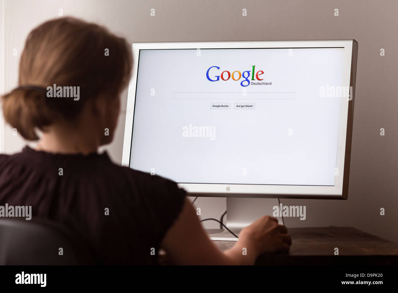 Woman looking at Internet site of the online search engine Google Stock Photo