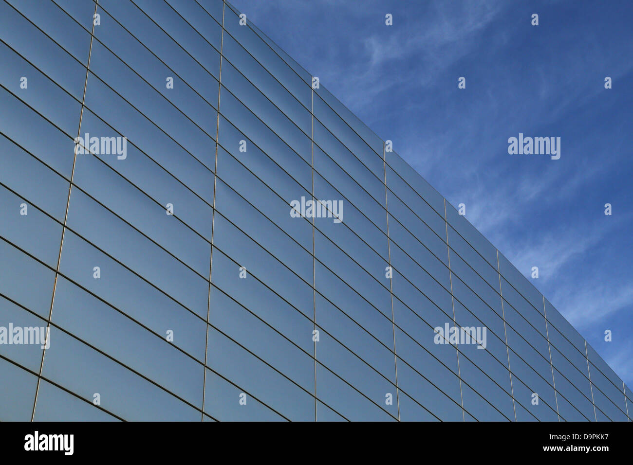 Office building glass exterior against blue sky Stock Photo - Alamy