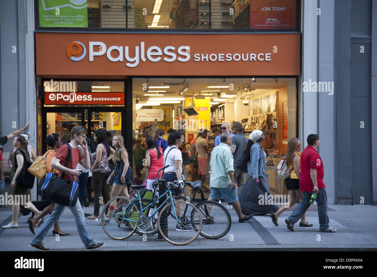 People walk by Payless Shoes, a brand name to attract people watching their spending especially in economically tight times. Stock Photo