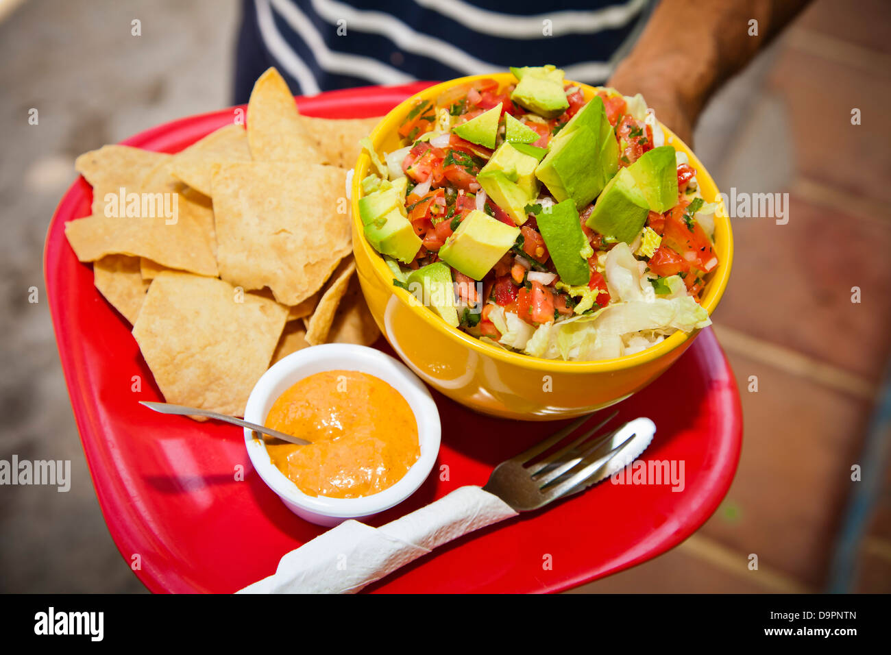 Hand holding serving of mexican food Stock Photo