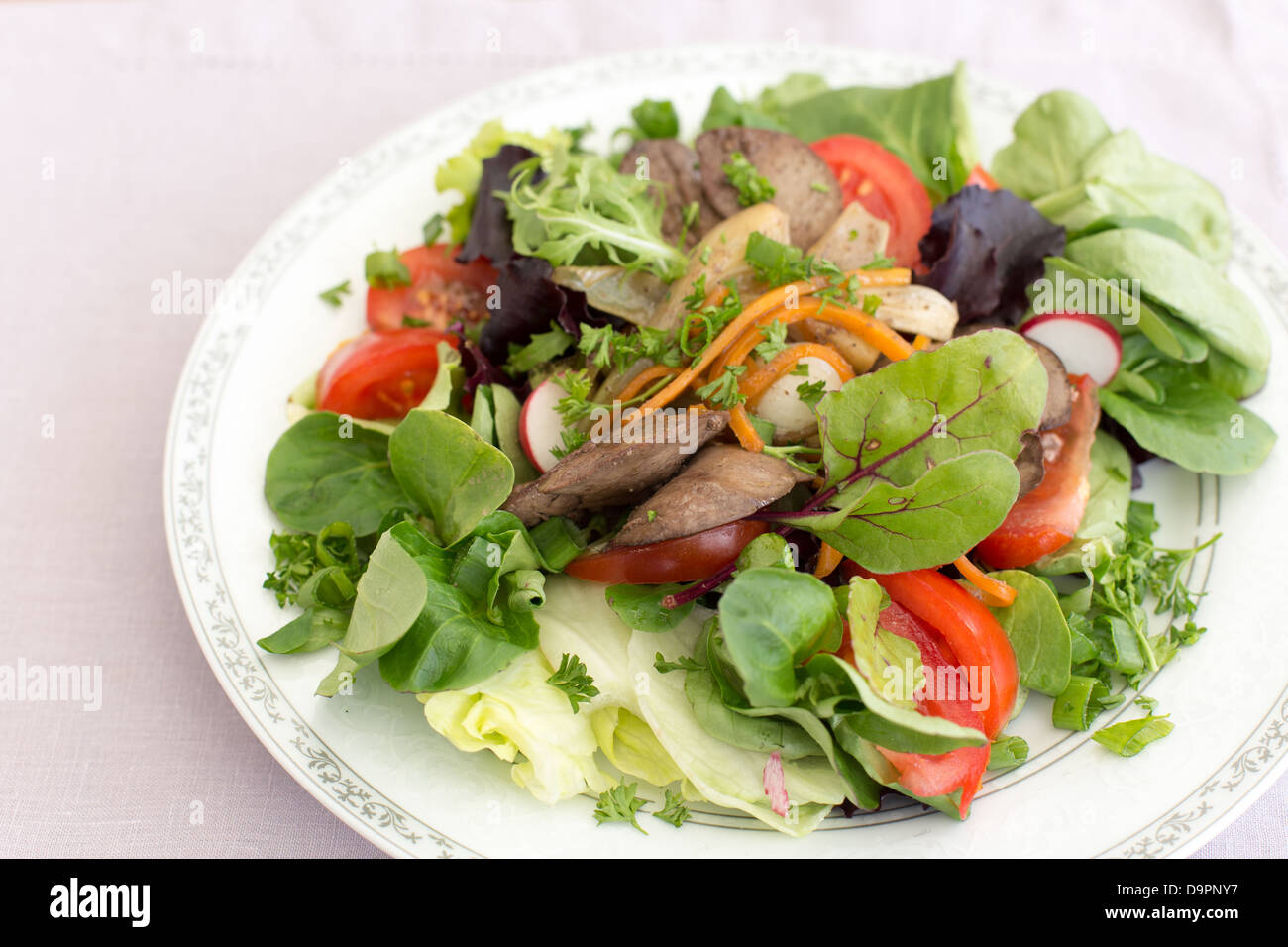 Delicious salad with fried rabbit liver and fresh vegetables Stock ...