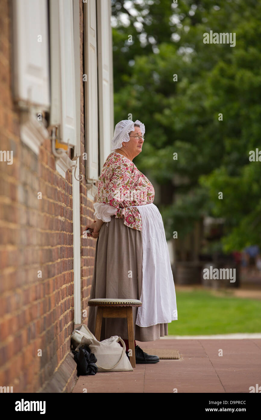Woman standing on doorstep at Colonial Williamsburg, Virginia, USA Stock Photo