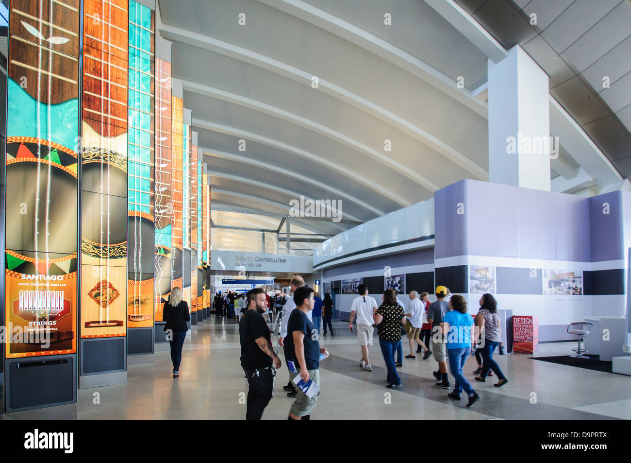 Travelers tour the new IEMS portals in the re-designed South Concourse at Los Angeles International Airport Stock Photo