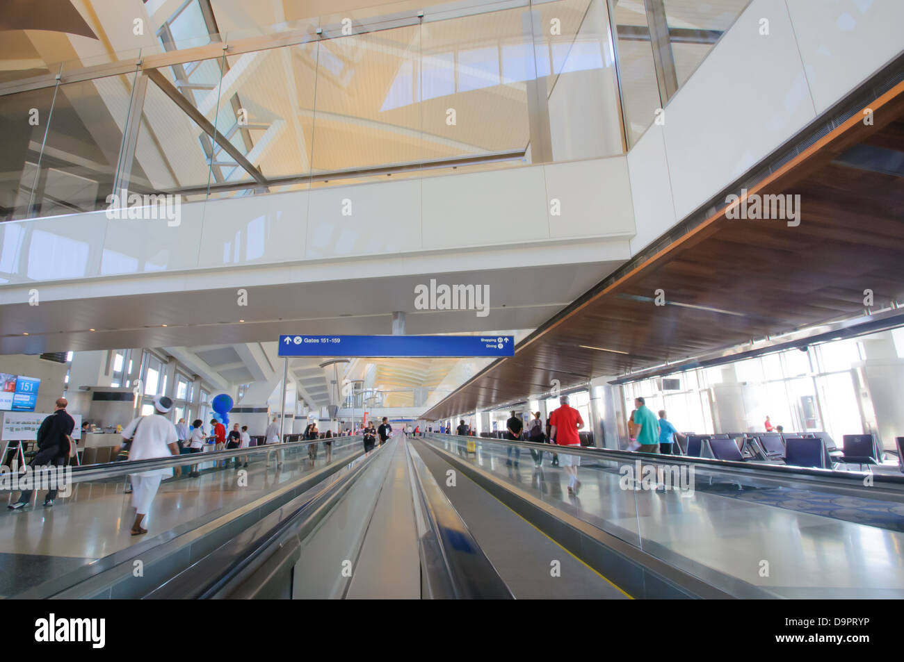 Travelers use people movers to pass through Tom Bradley terminal at LAX Stock Photo