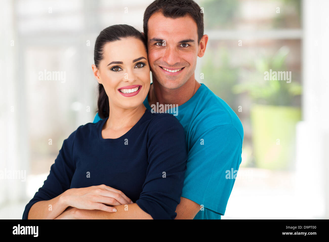 happy young couple hugging and smiling Stock Photo - Alamy