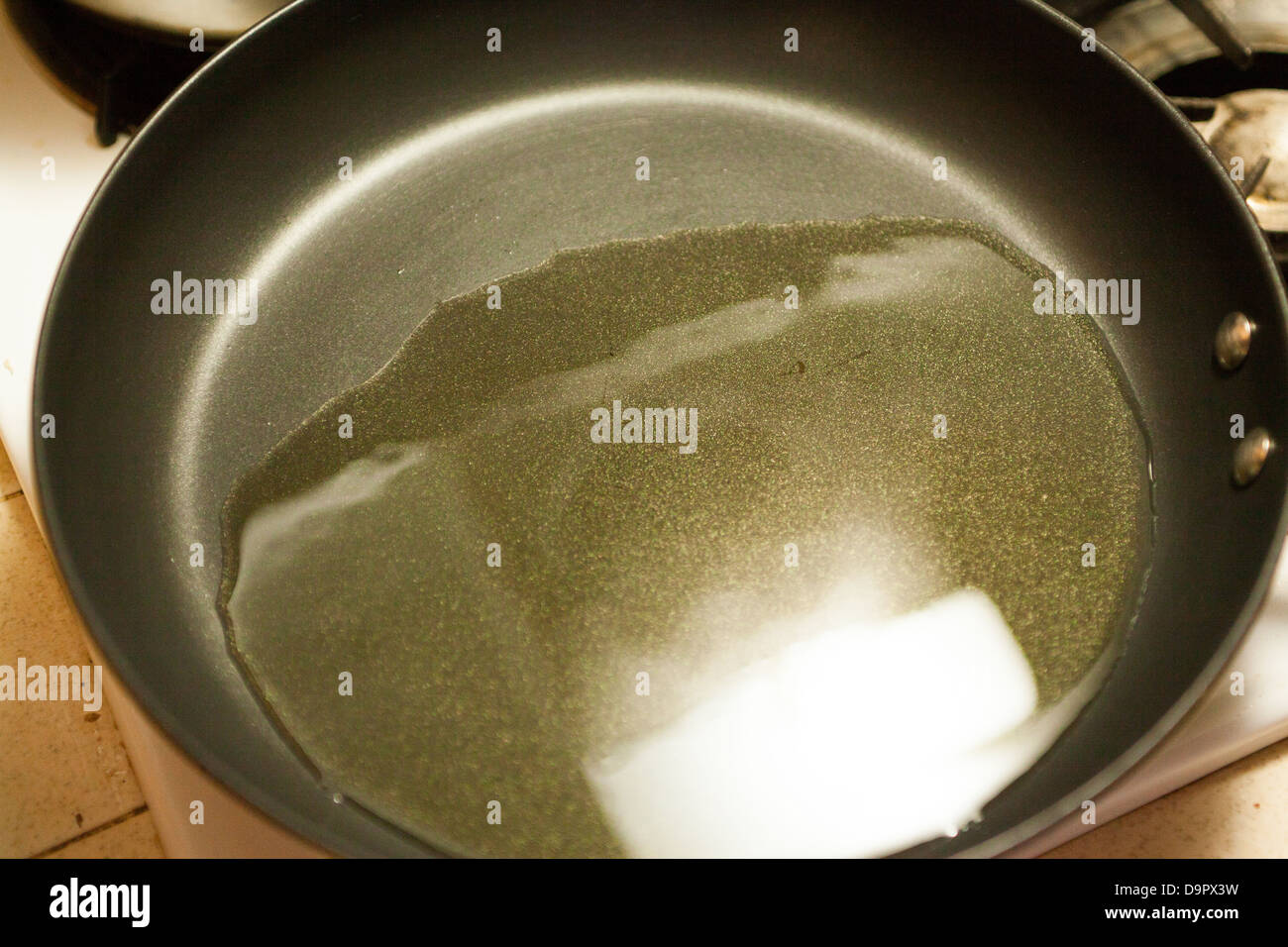 Hot oil in a Paula Dean nonstick frying pan from Walmart Stock Photo